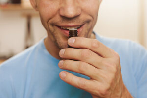How to Choose Essential Oils. Effectiveness of essential oils for men. Man smelling bottle